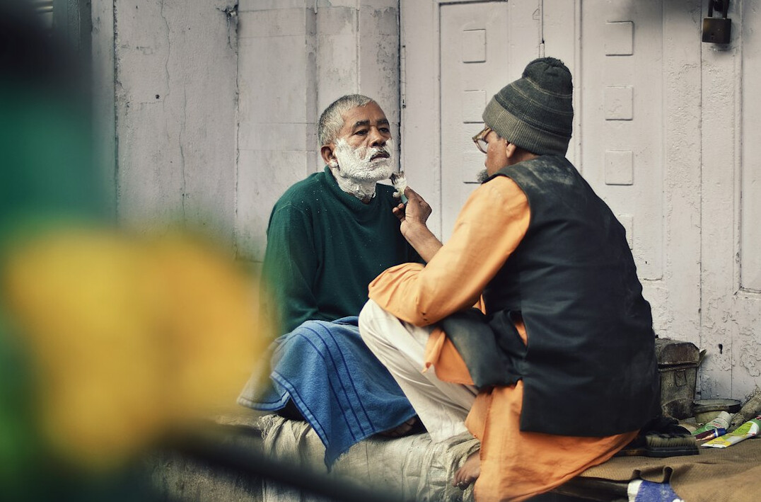 Older man in a trusting one-to-one conversation with a counselor in a calm room