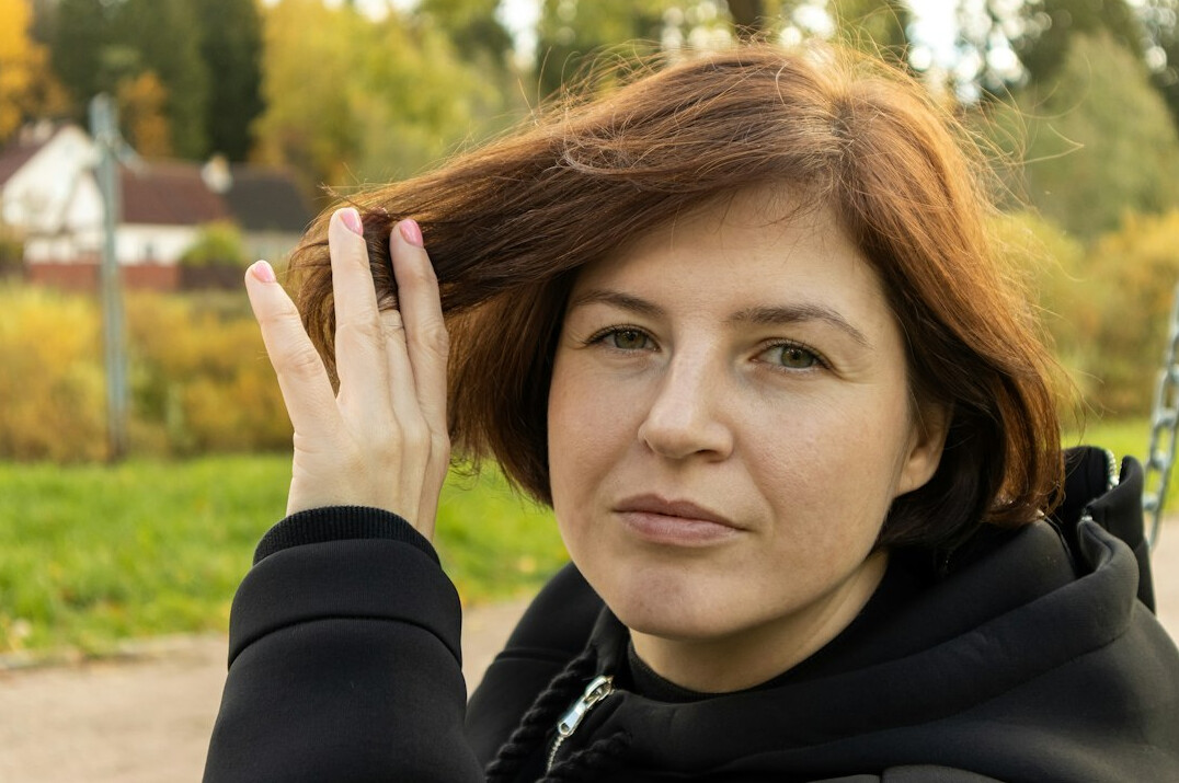 Portrait of a friendly German woman psychologist in her fifties with shoulder-length brown hair